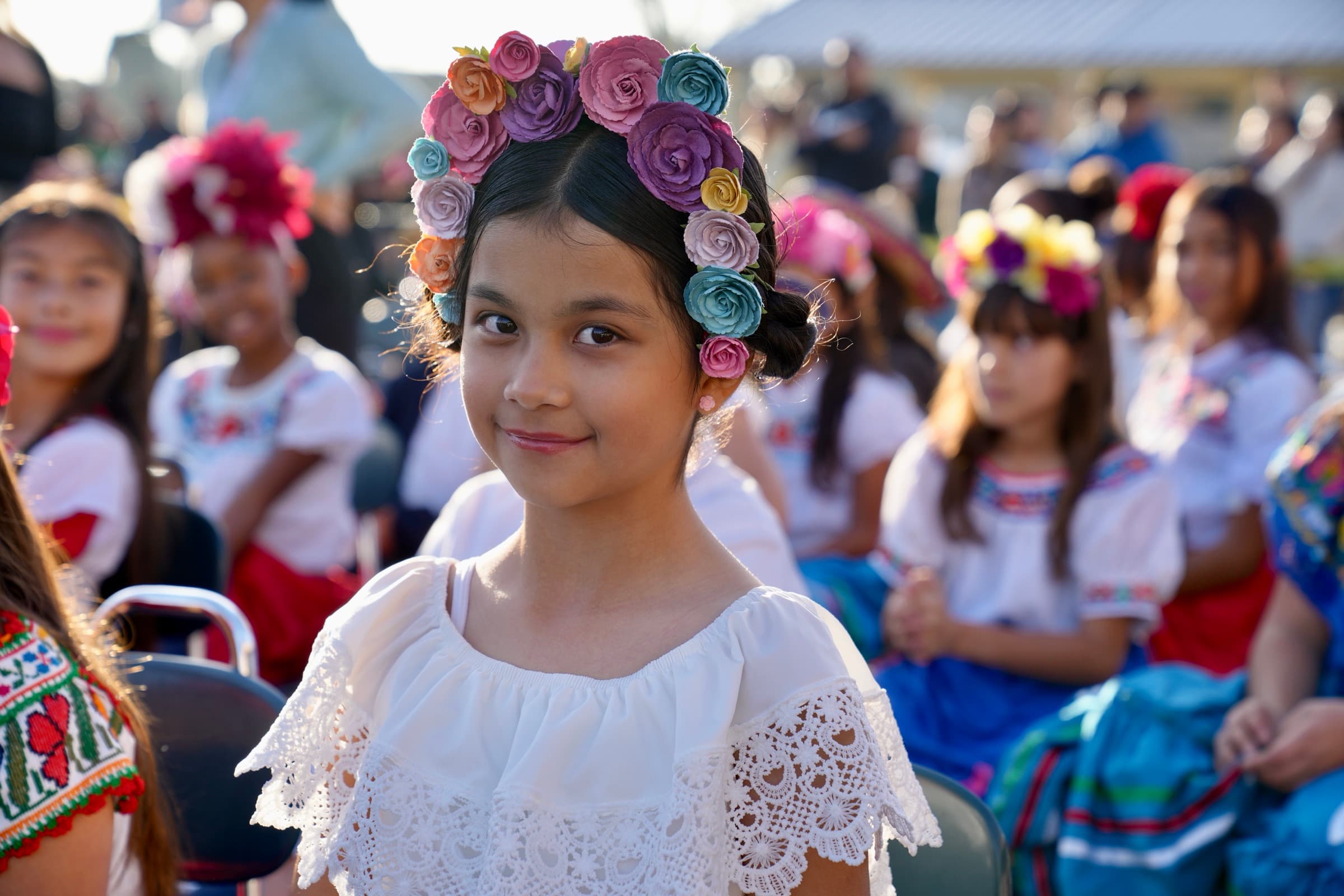 A Bellflower Unified student wears a flower crown at a school celebration