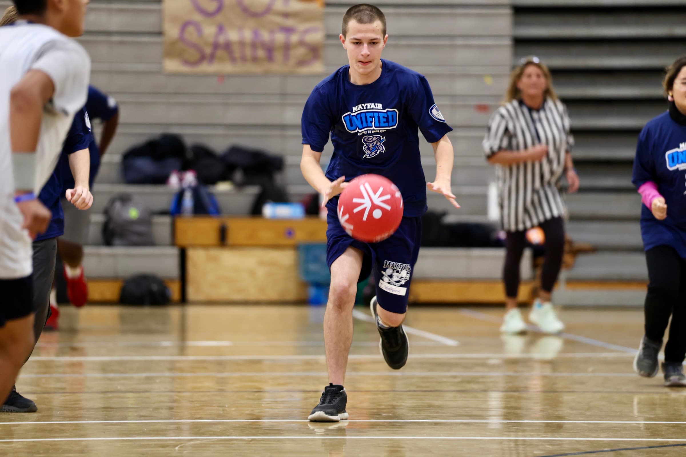 A Mayfair Unified student dribbles during an indoor game