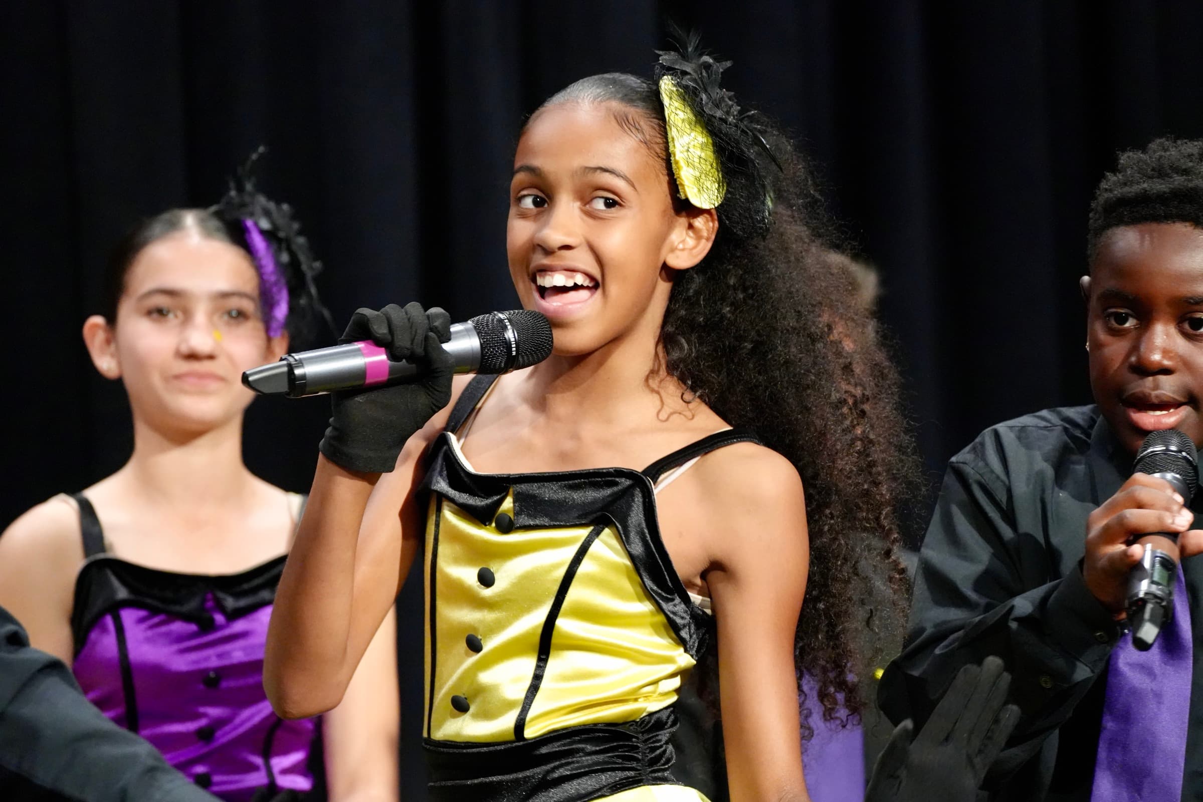 A Bellflower Unified student sings on stage during a school performance