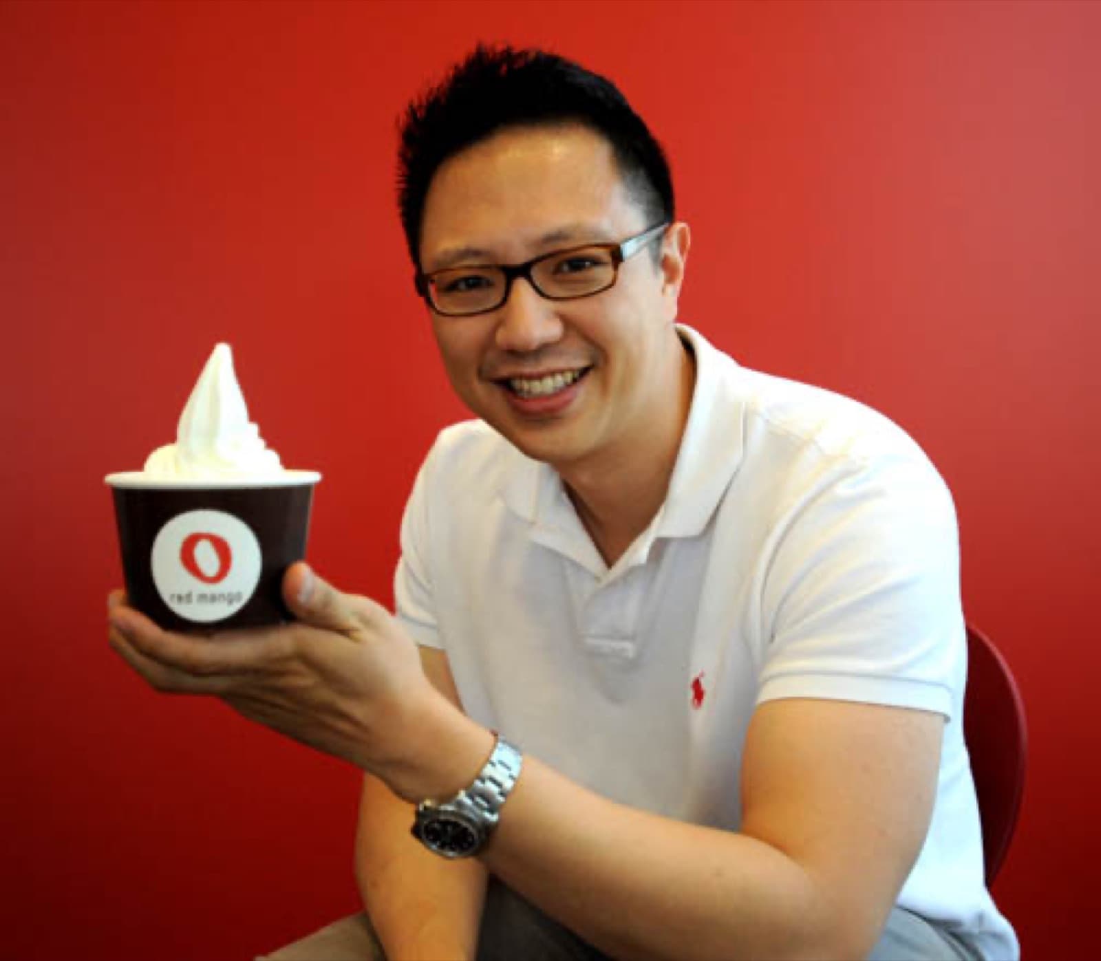 Daniel J. Kim holding a cup of Red Mango frozen yogurt